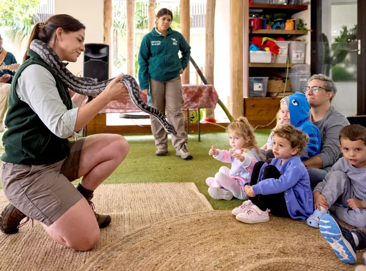 Taronga educator showing preschool kids a snake as part of Animals of the Dreaming Zoomobile workshop